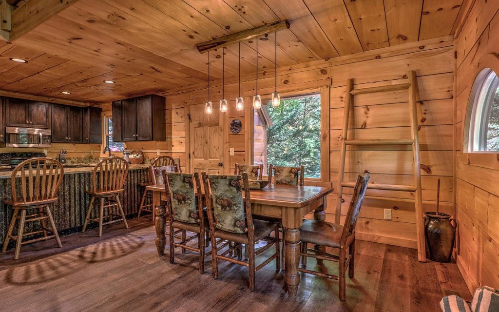 343 Muller Lane Ellijay, GA 30540 - Photo 13 of 35 a view of a dining room with furniture window and wooden floor
