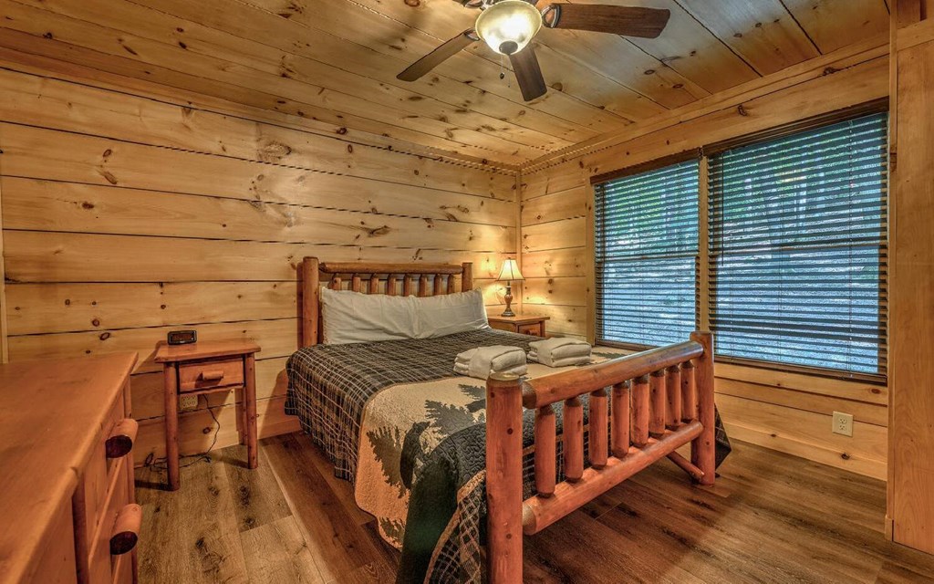 343 Muller Lane Ellijay, GA 30540 - Photo 19 of 35 a bedroom with a bed and wooden floor