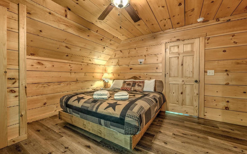 343 Muller Lane Ellijay, GA 30540 - Photo 25 of 35 a bed sitting in a bedroom next to a cabinet