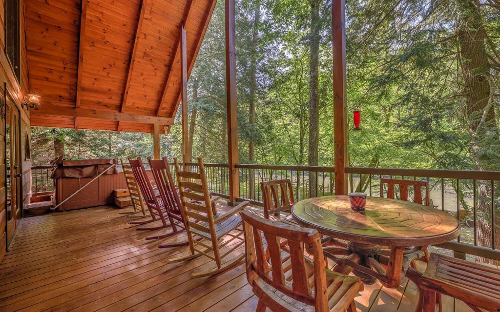 343 Muller Lane Ellijay, GA 30540 - Photo 7 of 35 a view of a balcony with chairs and wooden floor