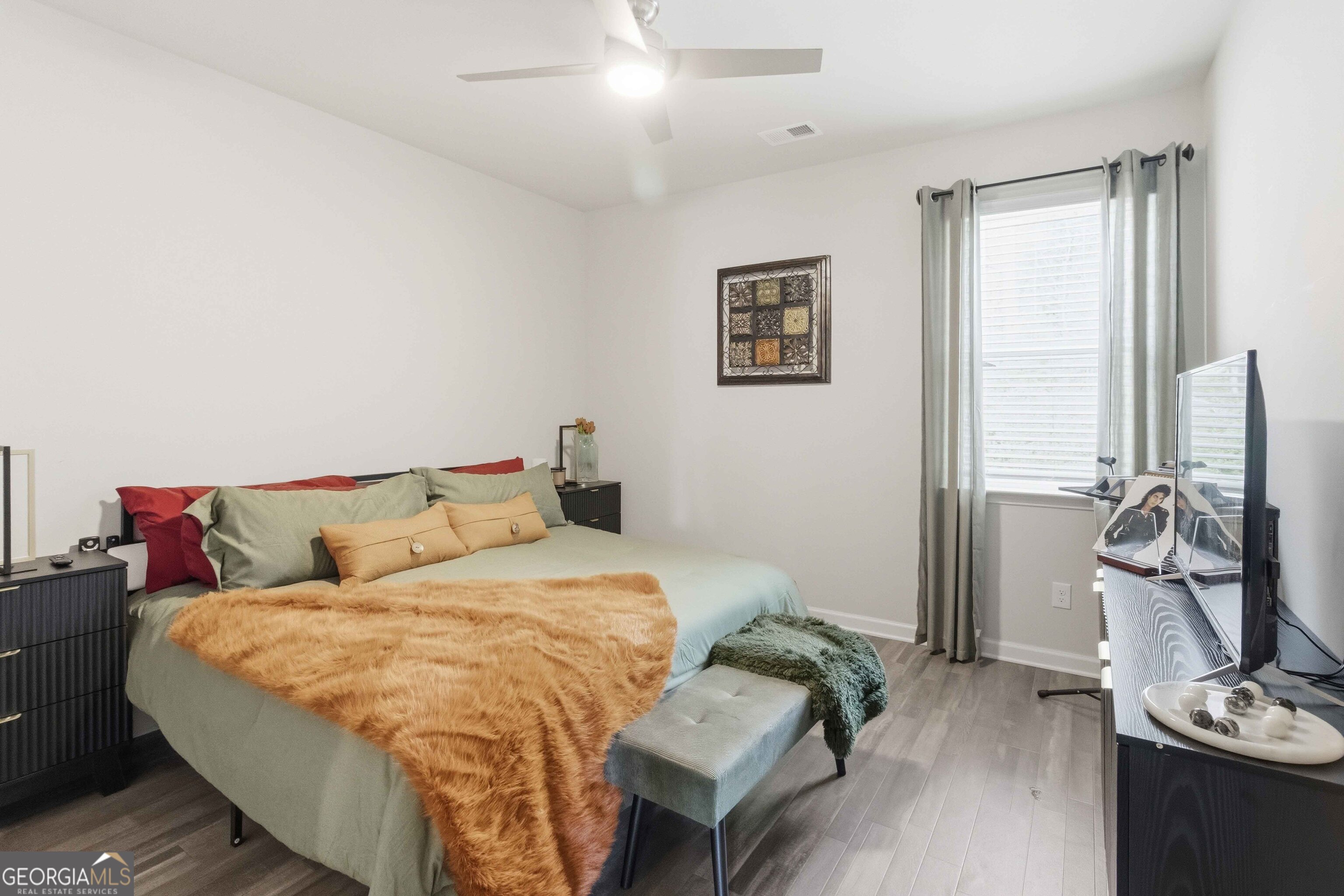 386 Paden Way Jonesboro, GA 30238 - Photo 22 of 29 a bedroom with a bed and wooden floor