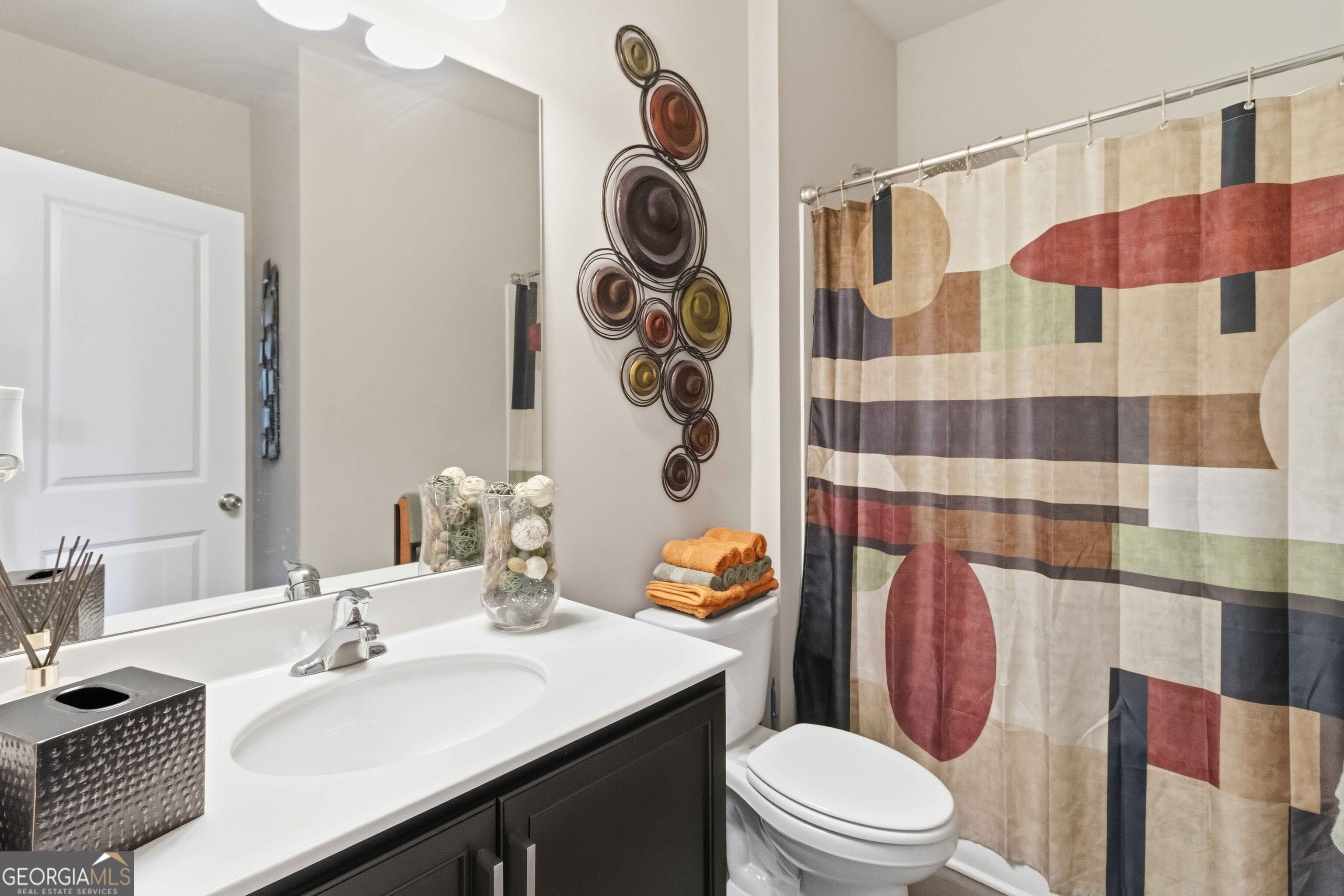 386 Paden Way Jonesboro, GA 30238 - Photo 24 of 29 a bathroom with a sink a toilet a shower and a mirror