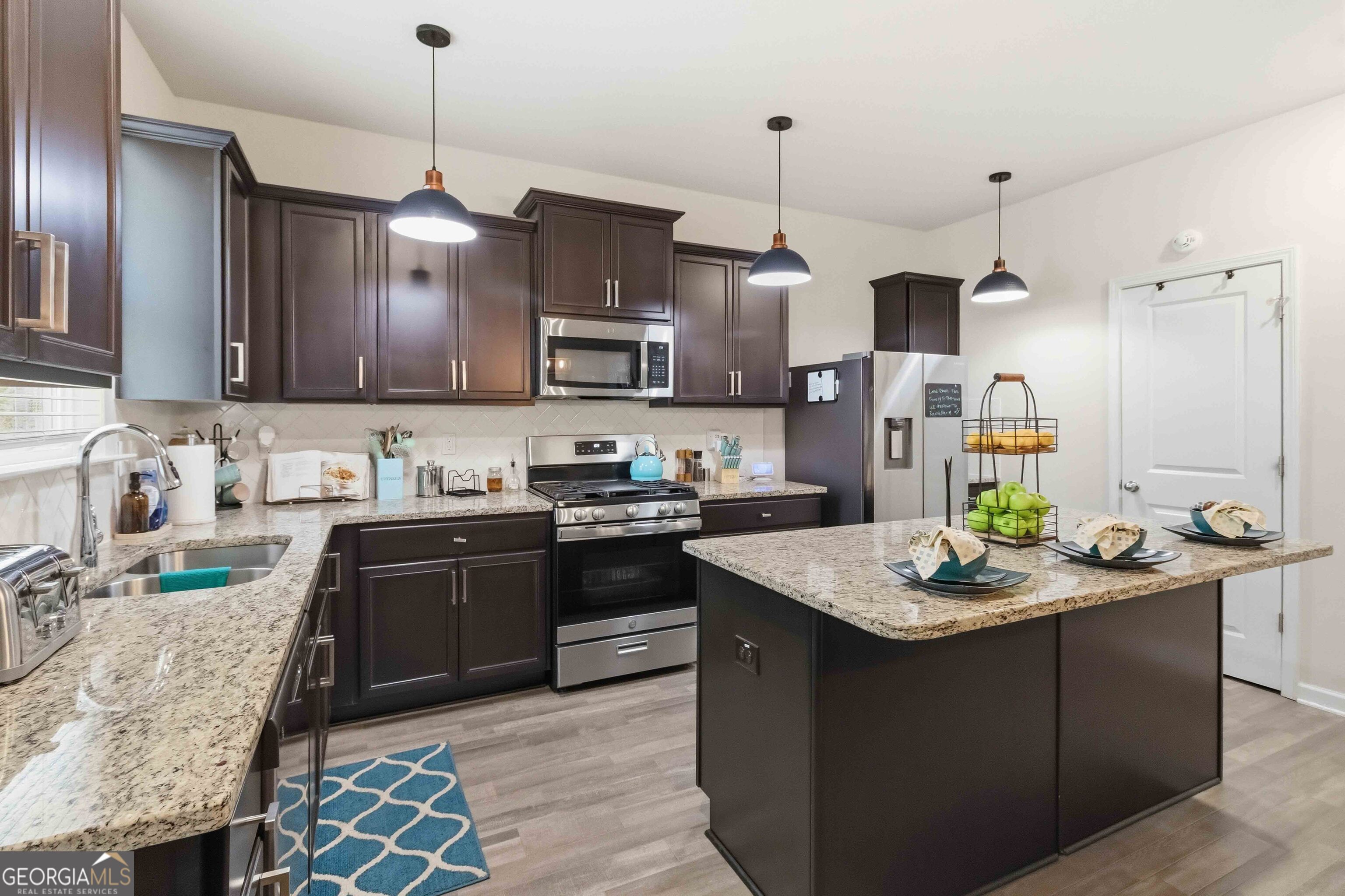 386 Paden Way Jonesboro, GA 30238 - Photo 9 of 29 a kitchen with stainless steel appliances kitchen island granite countertop a sink stove and refrigerator