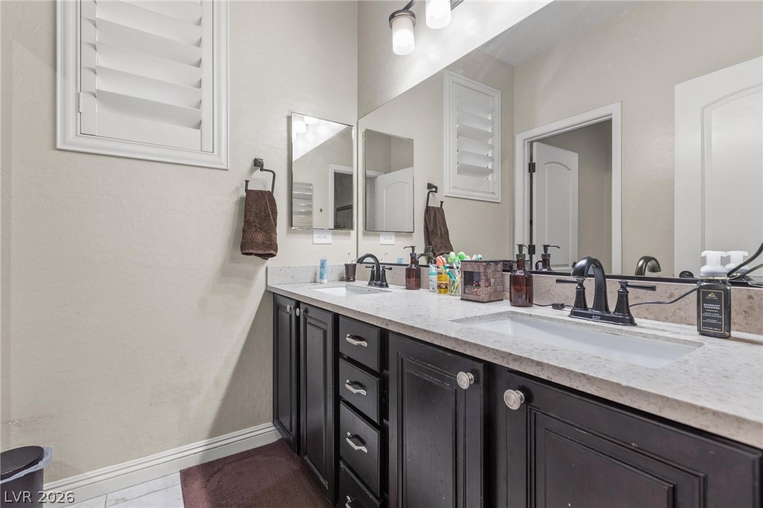 8431 Durango Ranch Court Las Vegas, NV 89113 - Photo 19 of 49 This spacious bathroom offers dual sinks, ideal for seamless daily routines.