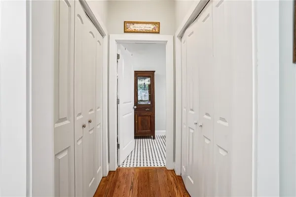 a view of a hallway with a wooden door