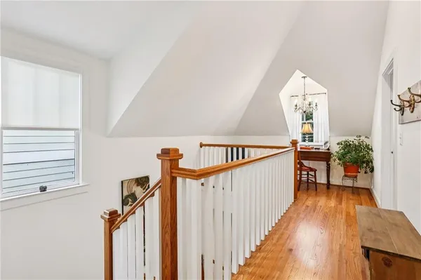 a view of entryway and hall with wooden floor