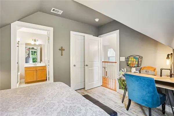 a bedroom with a bed and a dresser in it