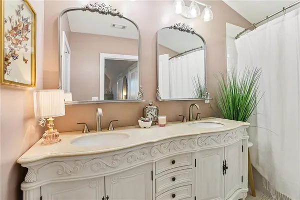a bathroom with a double vanity sink and mirror
