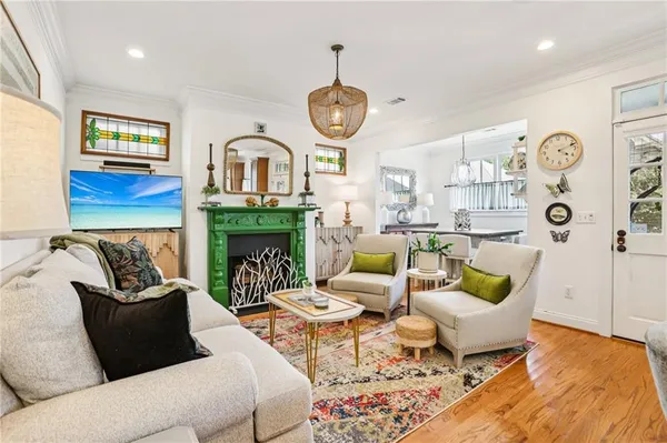 a living room with furniture a fireplace and a flat screen tv