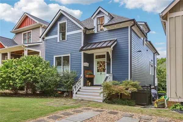 a aerial view of a house with a yard and potted plants
