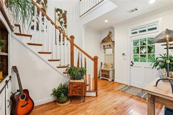a view of entryway and hall with wooden floor