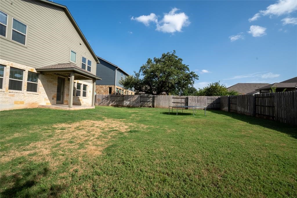 1333 Terrace View Drive Georgetown, TX 78628 - Photo 35 of 35 Generous grassy yard with a covered patio provides ample space for outdoor living.