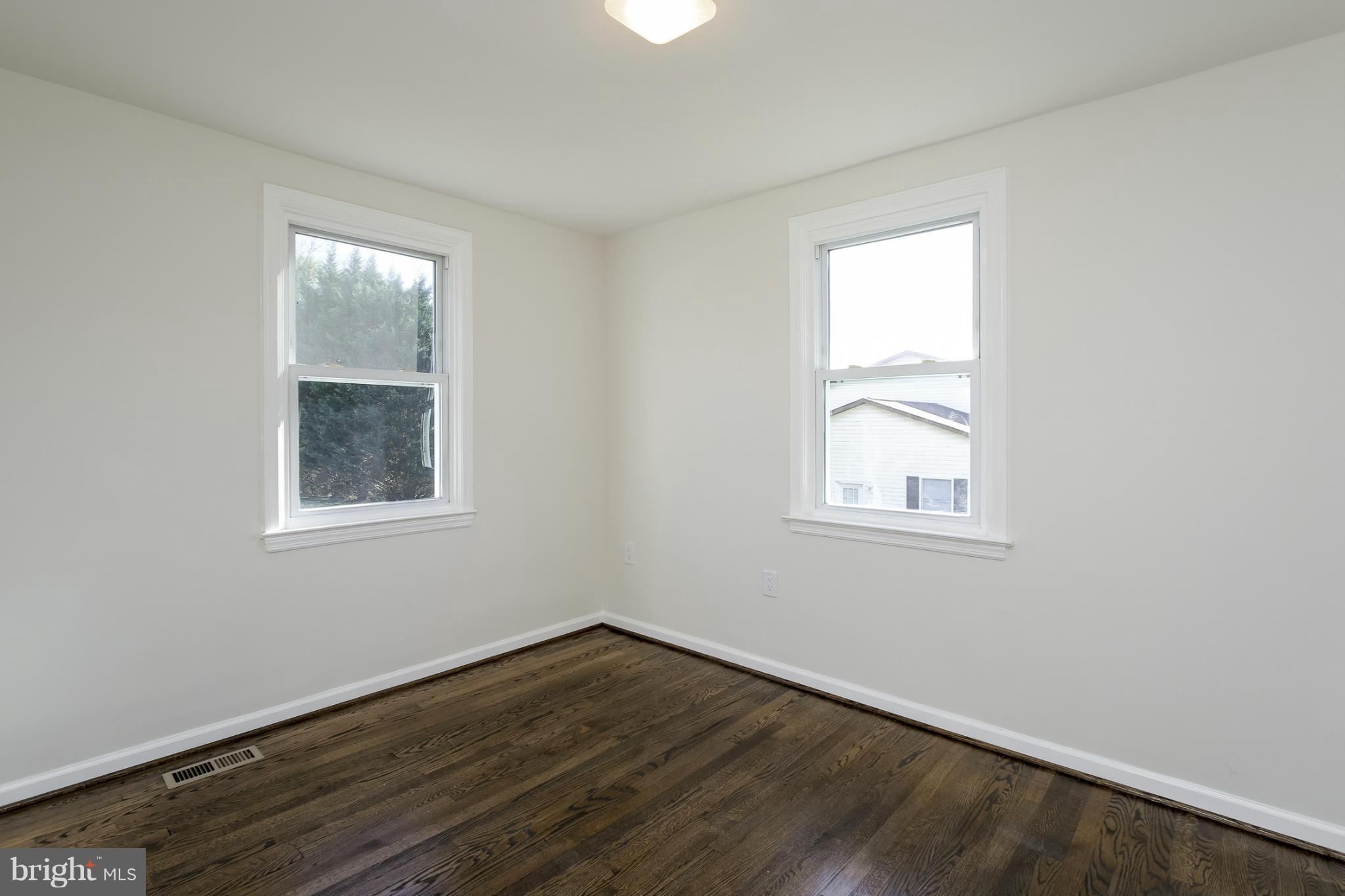 3313 Chapman Road Randallstown, MD 21133 - Photo 11 of 30 an empty room with wooden floor and windows