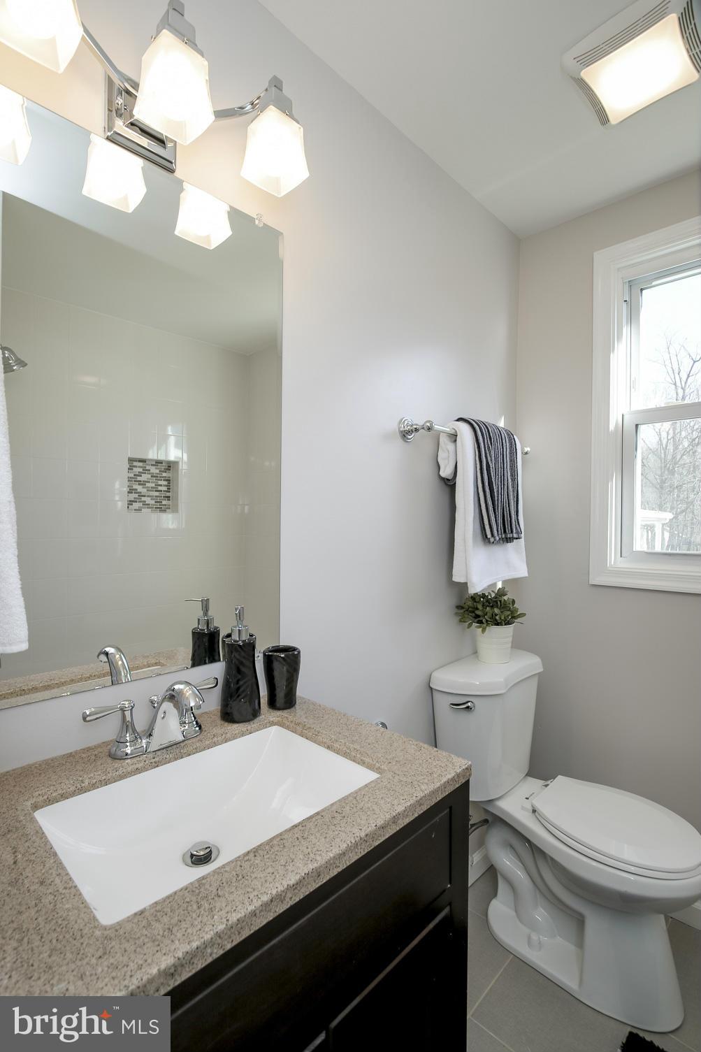 3313 Chapman Road Randallstown, MD 21133 - Photo 13 of 30 a bathroom with a sink and a mirror
