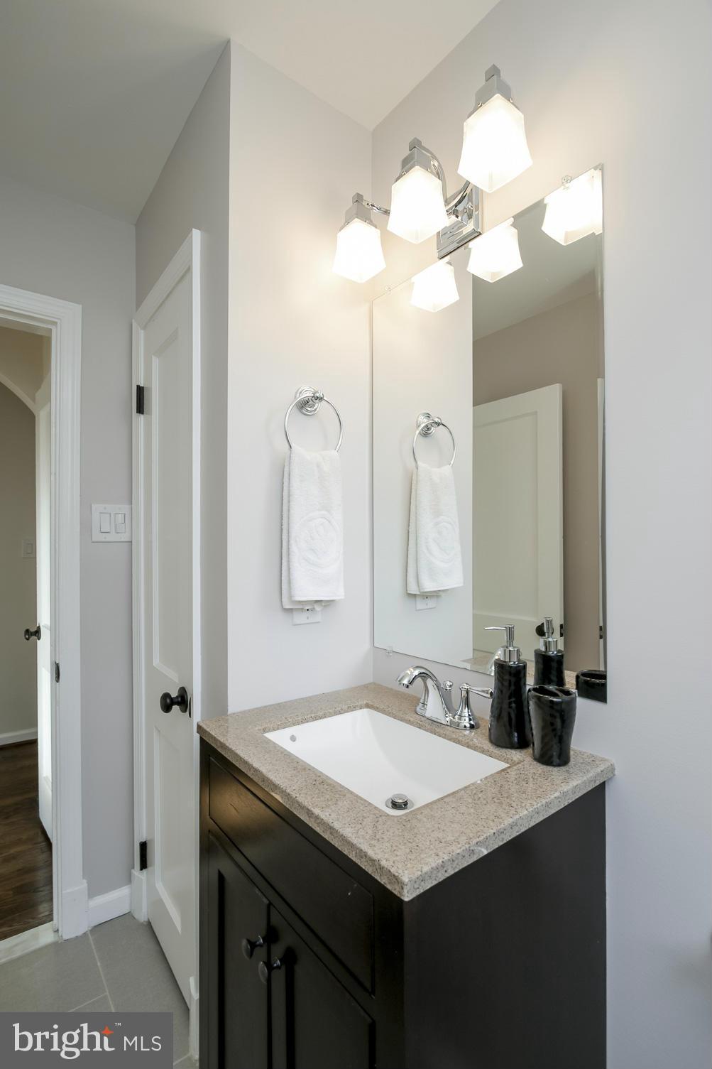 3313 Chapman Road Randallstown, MD 21133 - Photo 14 of 30 a bathroom with a sink a light fixture and a mirror