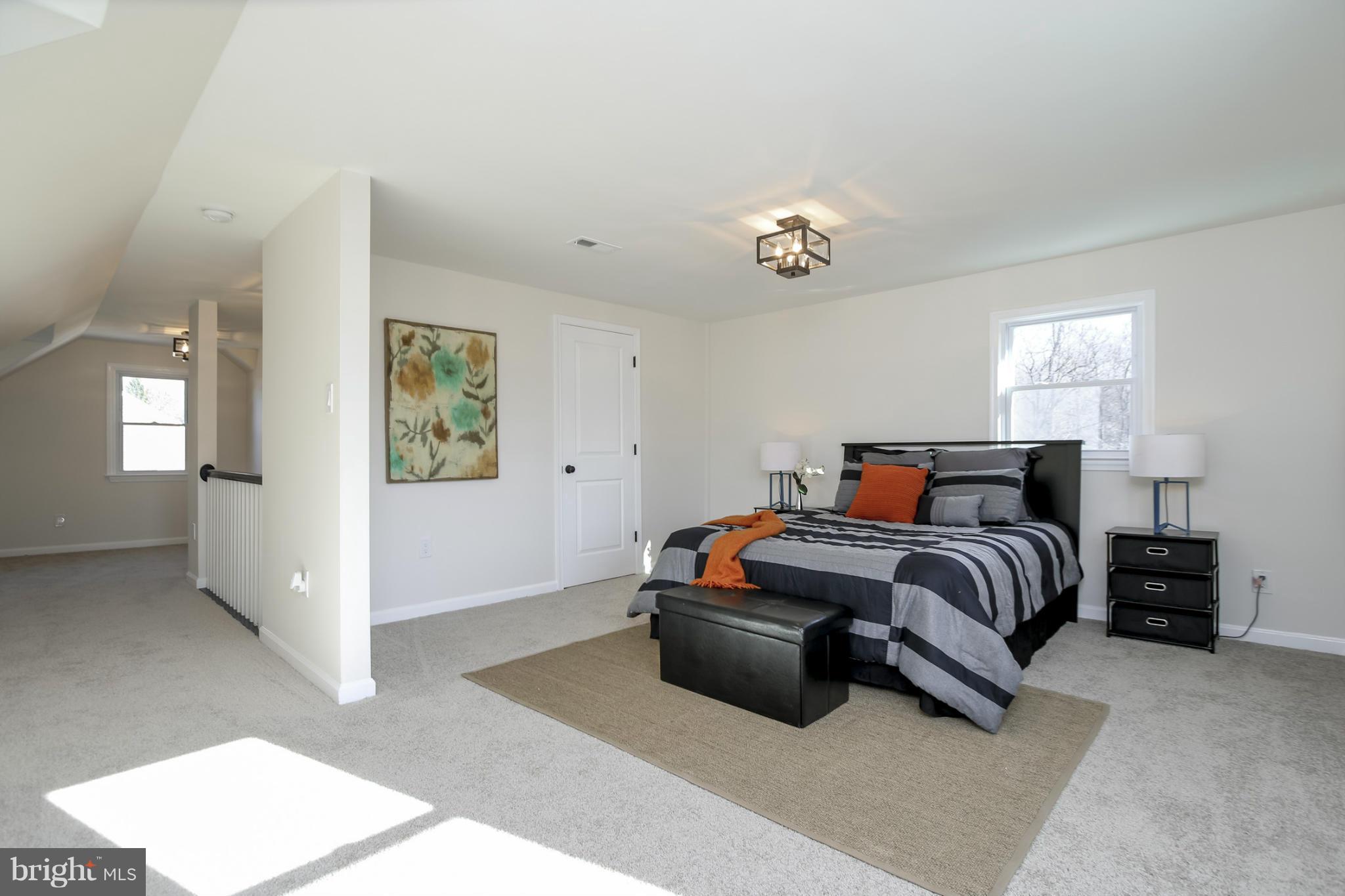 3313 Chapman Road Randallstown, MD 21133 - Photo 17 of 30 a bedroom with a bed and a chandelier