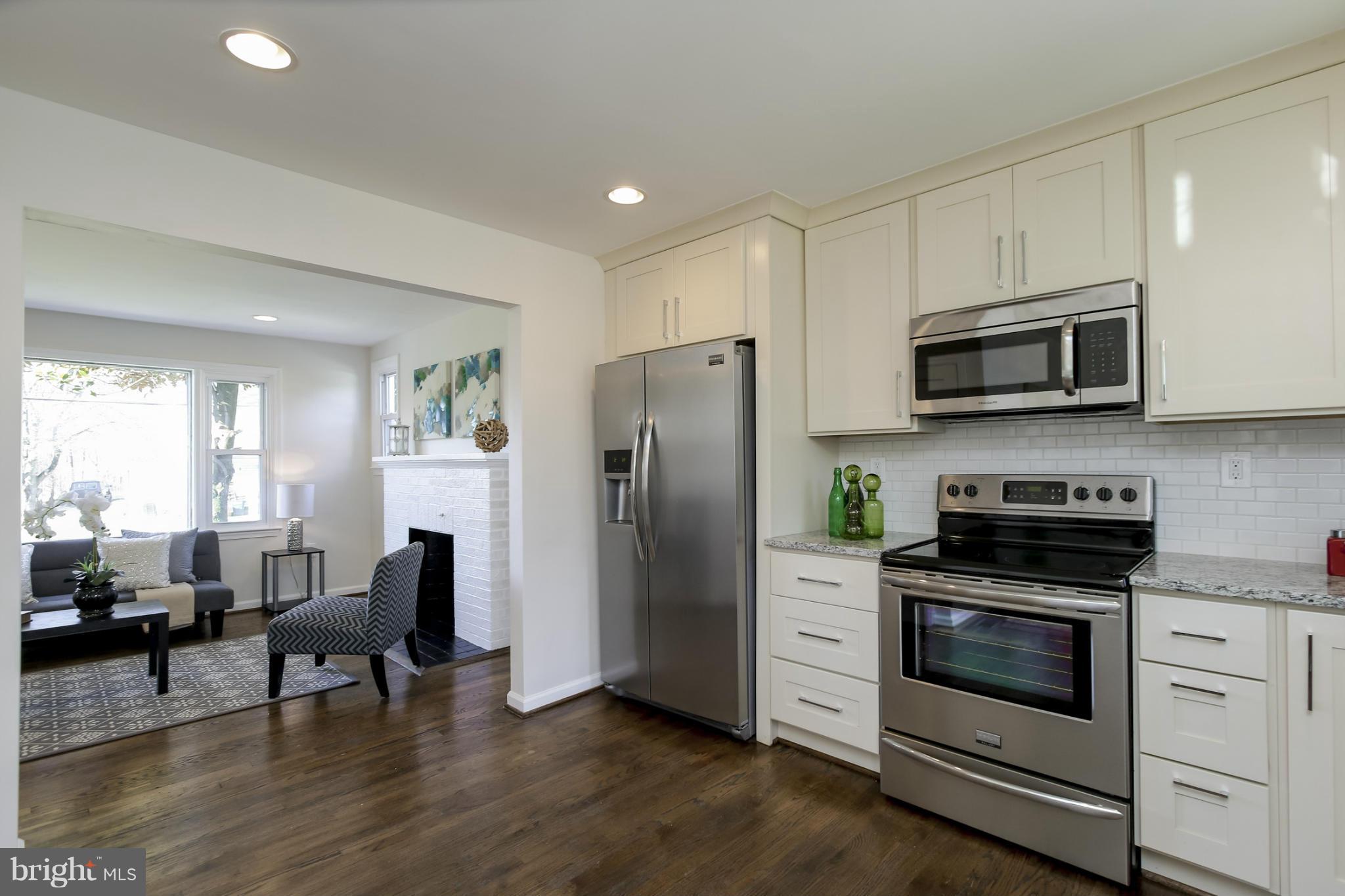 3313 Chapman Road Randallstown, MD 21133 - Photo 7 of 30 a kitchen with stainless steel appliances a stove microwave and refrigerator