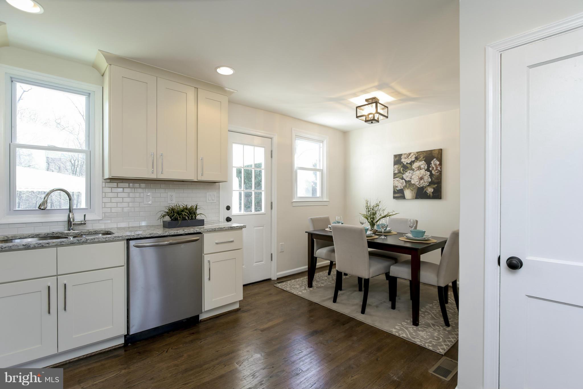 3313 Chapman Road Randallstown, MD 21133 - Photo 8 of 30 a kitchen with sink cabinets and wooden floor