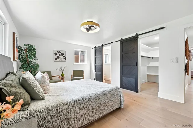 a bedroom with a bed and a chandelier