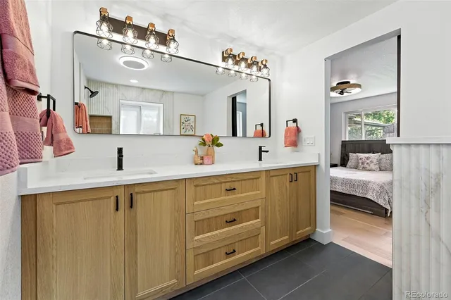 a en suite bathroom with a double vanity sink and a mirror
