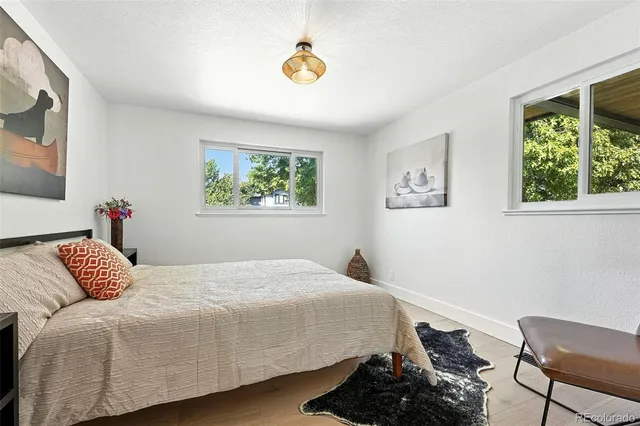 a bedroom with a bed and wooden floor