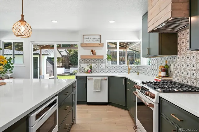 a kitchen with stainless steel appliances a stove and a sink