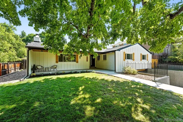 a front view of house with yard and green space