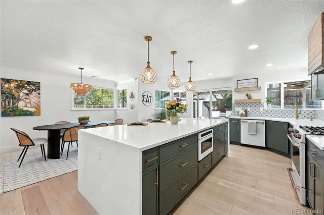a kitchen with a sink stove and wooden cabinets