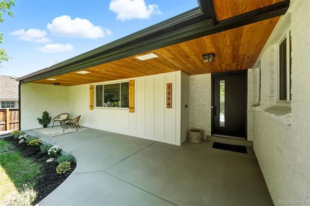 a backyard of a house with table and chairs