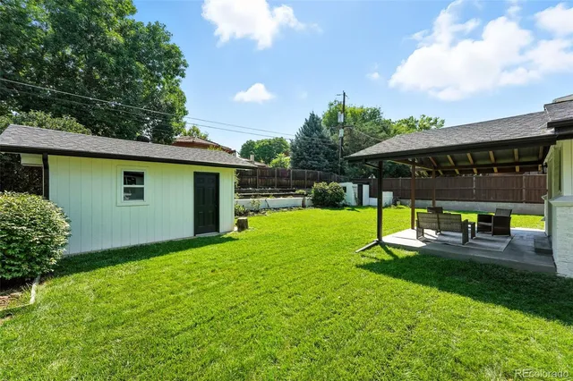 a view of a backyard with sitting area