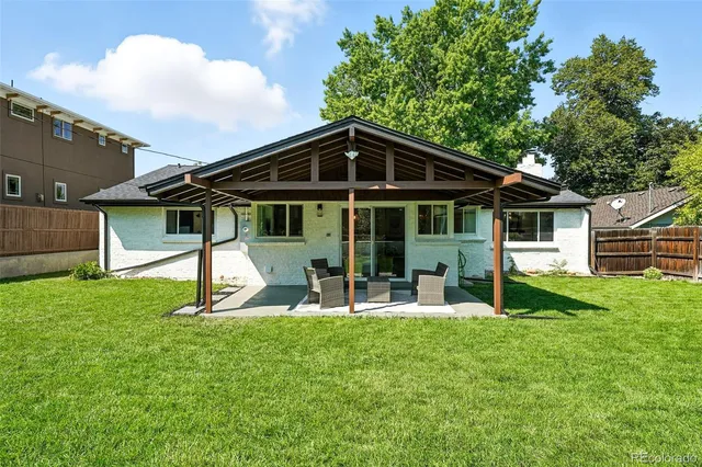 a view of a house with a yard and sitting area