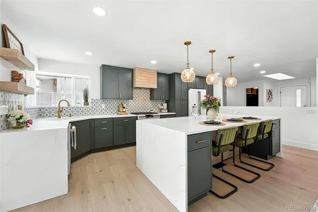 a kitchen with a sink a counter space appliances and cabinets