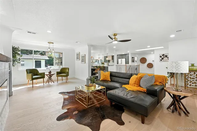 a living room with furniture and kitchen view