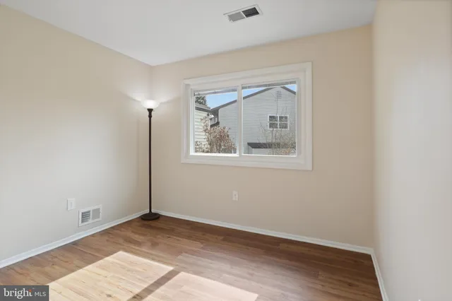 a view of an empty room and wooden floor