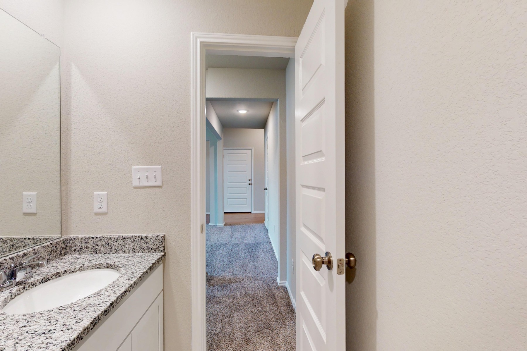 19913 Schatz Way Manor, TX 78653 - Photo 27 of 37 a bathroom with a granite countertop sink and a mirror