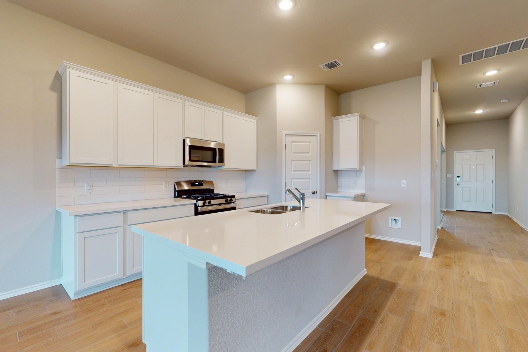 19913 Schatz Way Manor, TX 78653 - Photo 3 of 37 a kitchen with a sink a stove a microwave and a refrigerator