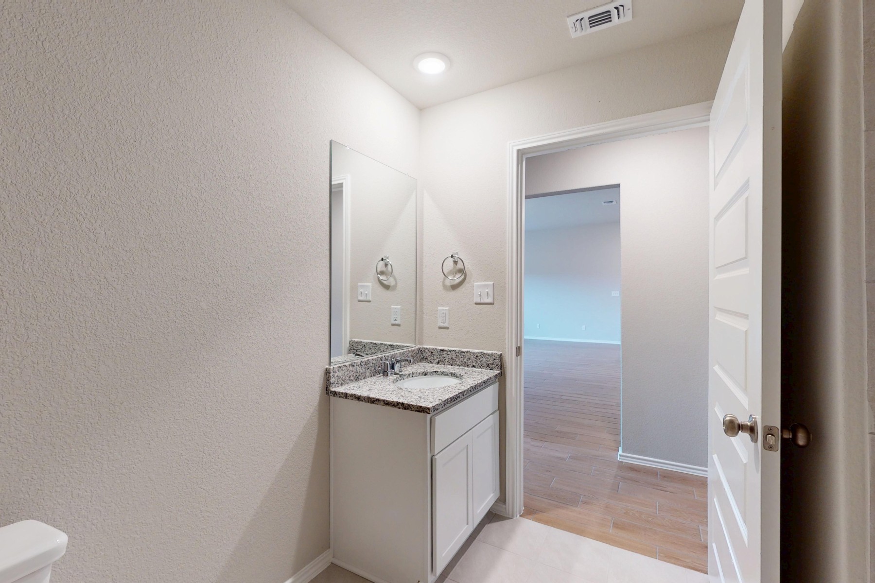 19913 Schatz Way Manor, TX 78653 - Photo 31 of 37 a bathroom with a granite countertop sink and a mirror