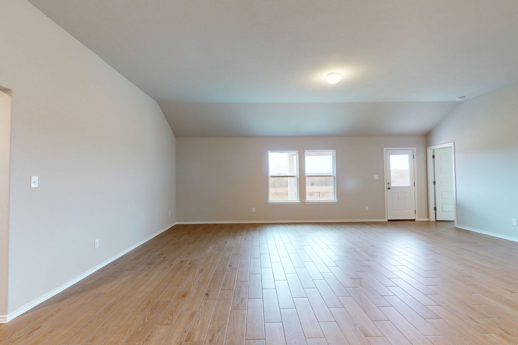 19913 Schatz Way Manor, TX 78653 - Photo 8 of 37 an empty room with wooden floor and windows