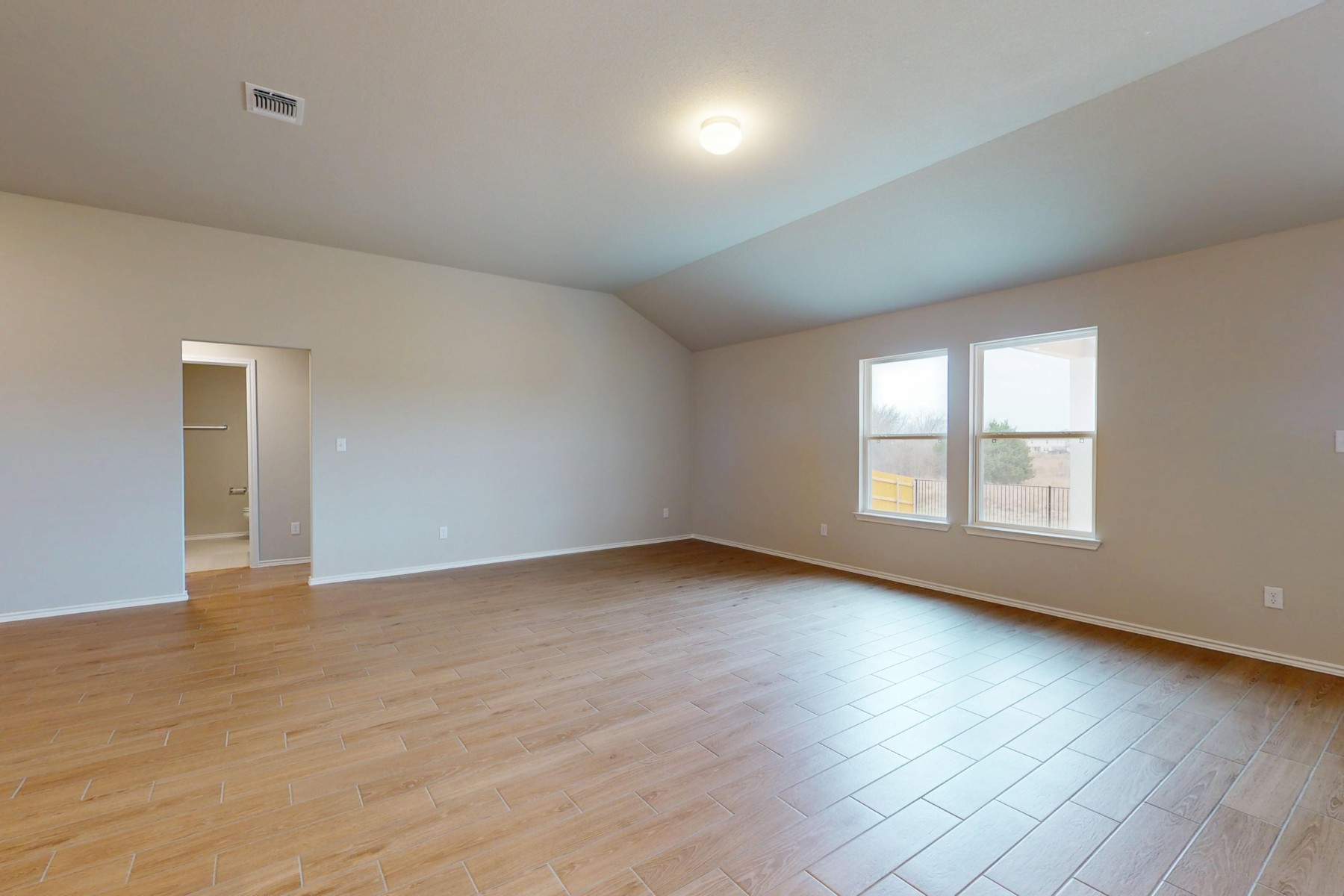 19913 Schatz Way Manor, TX 78653 - Photo 9 of 37 a view of an empty room with wooden floor and a window