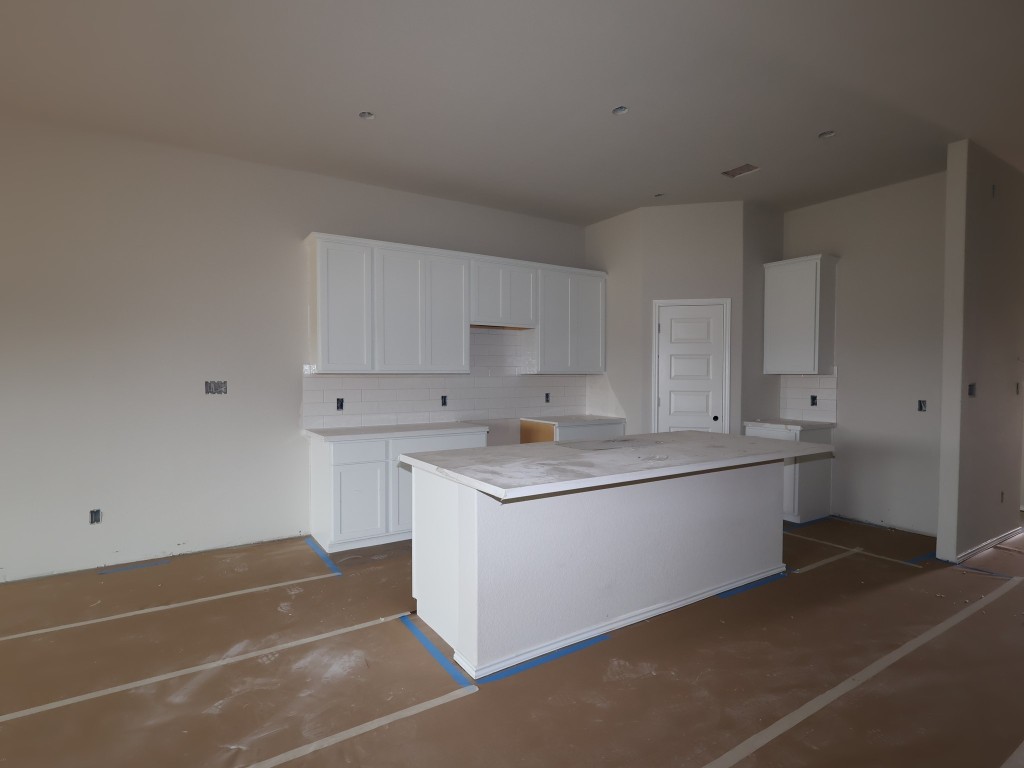 19913 Schatz Way Manor, TX 78653 - Photo 9 of 20 a kitchen with stainless steel appliances a sink stove and white cabinets