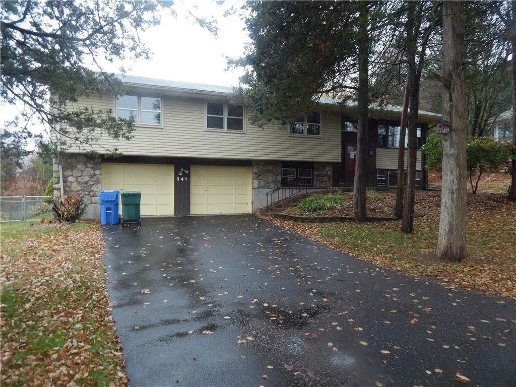 a view of a house with a yard and garage