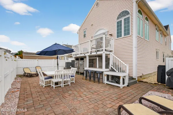 a view of a patio with a table and chairs