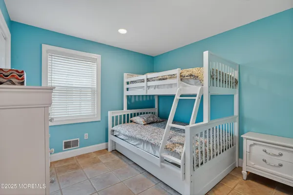 a bedroom with two beds and painted wall
