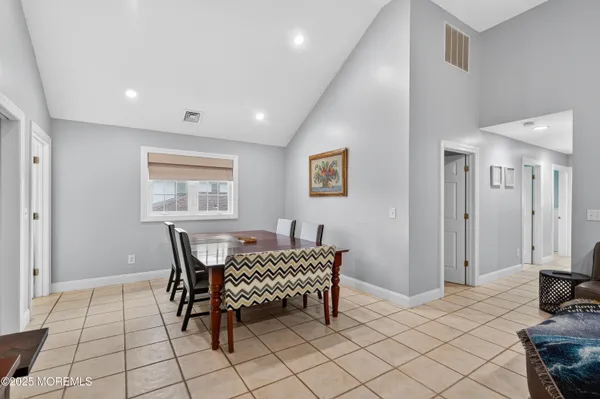 a dining room with furniture and wooden floor