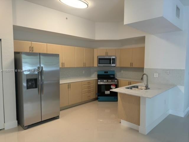 a kitchen with a sink appliances and cabinets