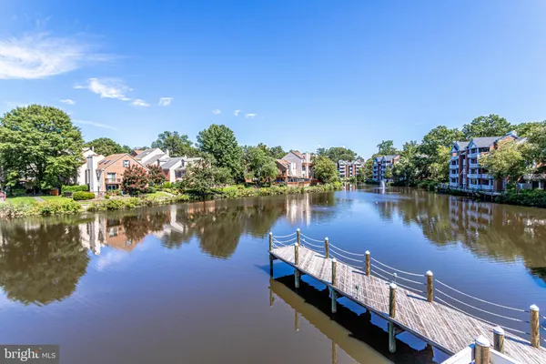 a view of a lake with houses in the background