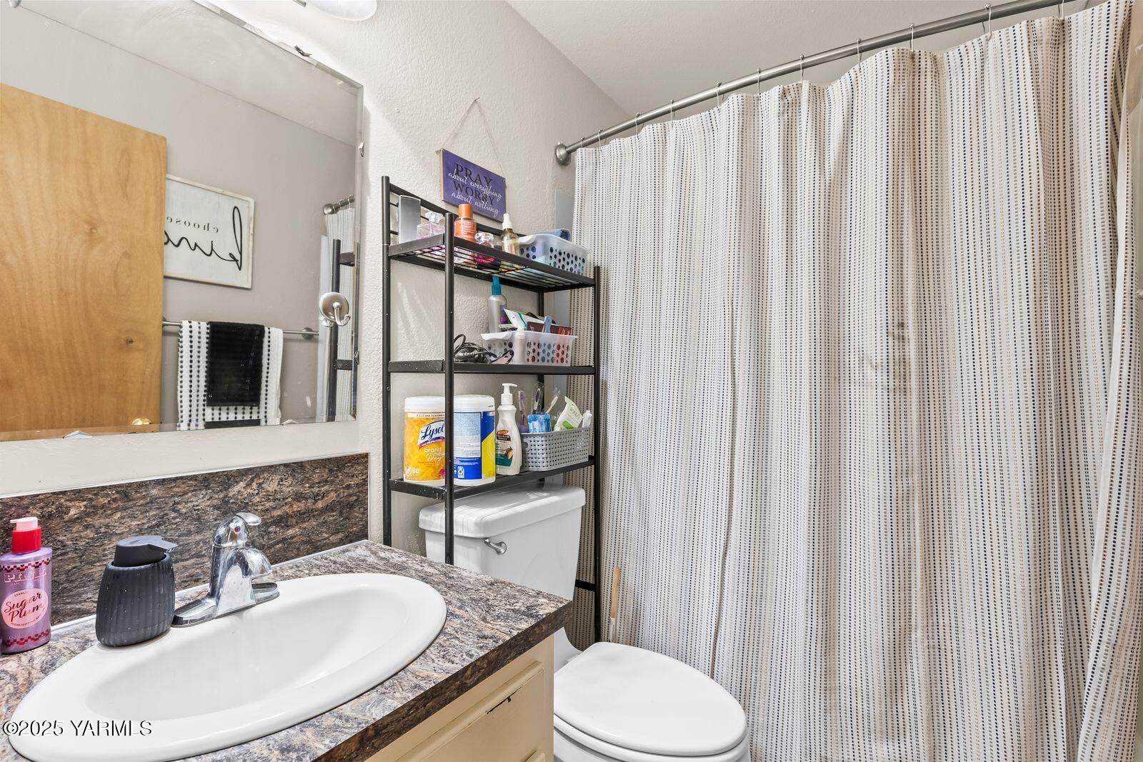 307 South 76th Avenue Yakima, WA 98908 - Photo 23 of 36 a bathroom with a sink toilet and shower