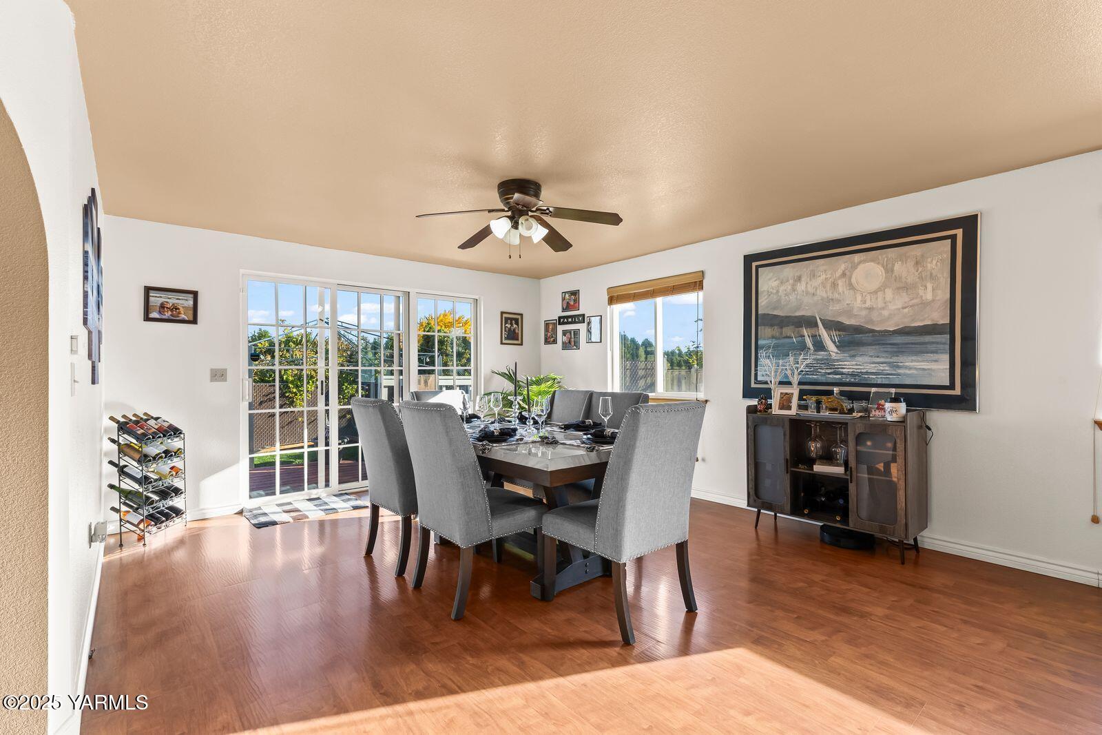 307 South 76th Avenue Yakima, WA 98908 - Photo 35 of 36 a dining room with furniture window and wooden floor