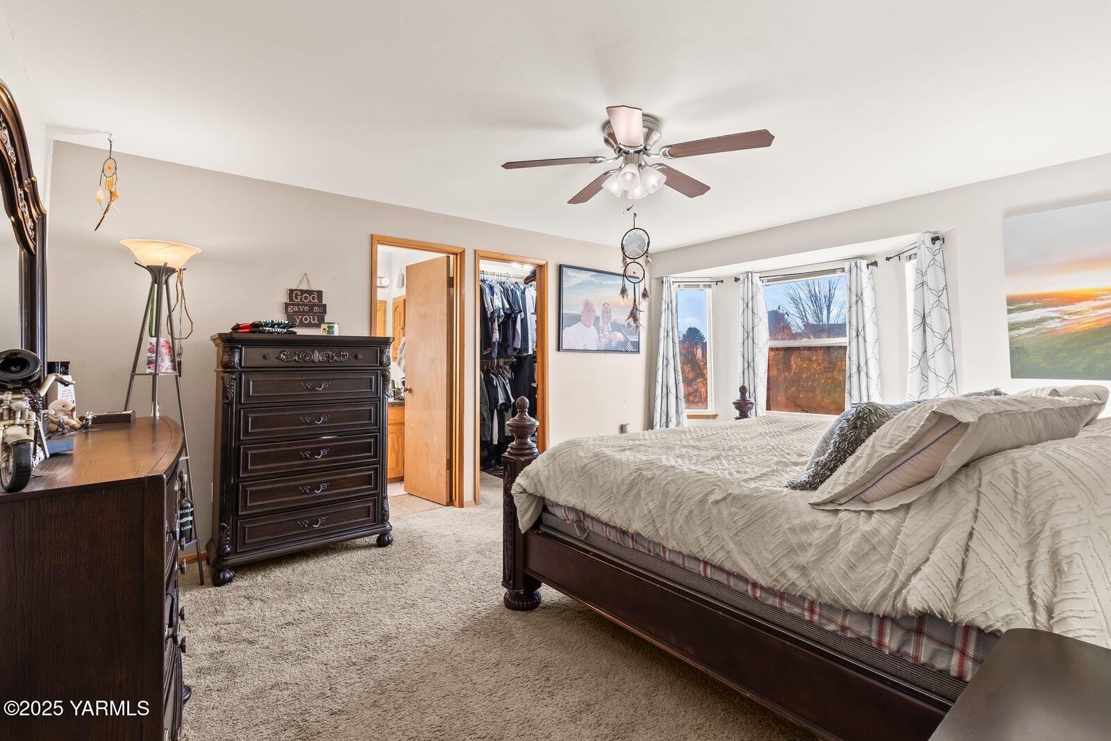 307 South 76th Avenue Yakima, WA 98908 - Photo 7 of 36 a bedroom with a bed and a chandelier