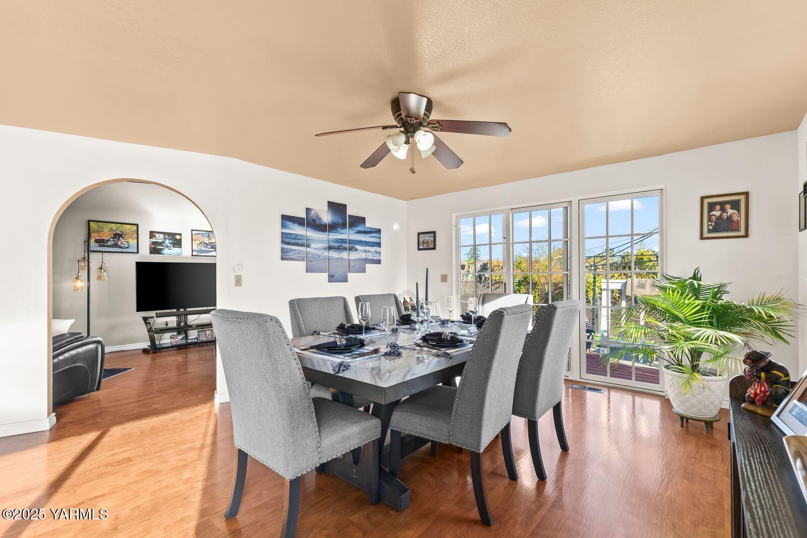 307 South 76th Avenue Yakima, WA 98908 - Photo 7 of 36 a dining room with furniture potted plants and wooden floor